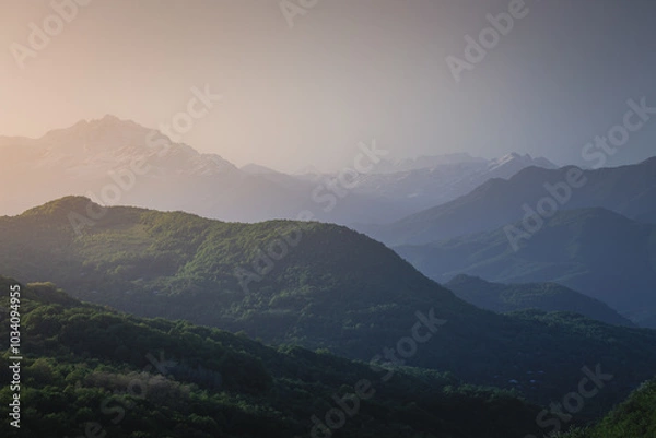 Fototapeta mountain ranges at sunset in the haze