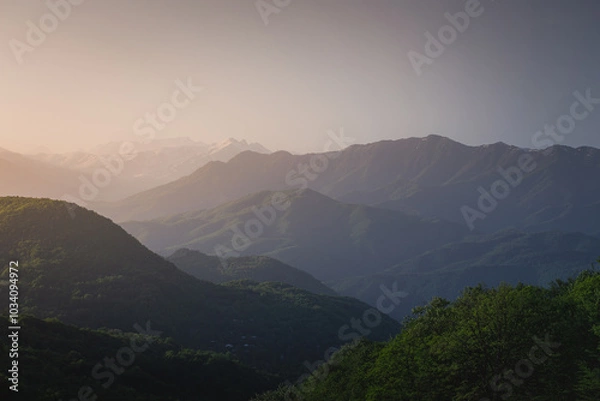 Fototapeta mountain ranges at sunset in the haze