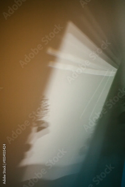 Obraz Light casts abstract shapes on a wall