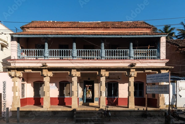 Obraz  Exterior facade of an old house with pillared columns, a beautiful balcony and traditional architecture.