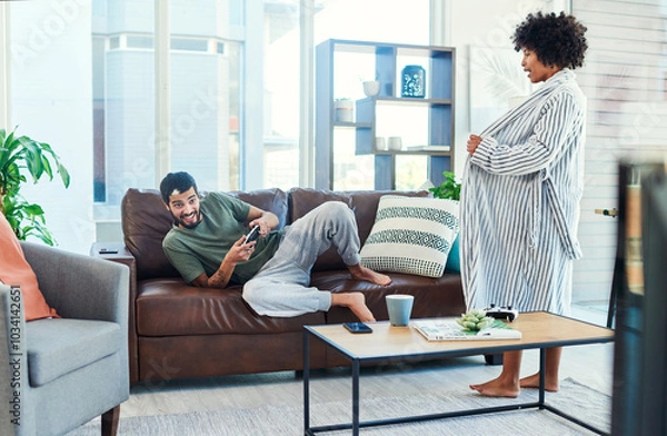 Fototapeta Couple, flash and man gaming in living room of home with controller for challenge or competition. Distraction, frustration or lonely with guy and woman in apartment for flirting or sexual temptation