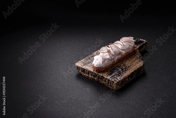 Obraz Sweet eclair with custard decorated with coconut slices
