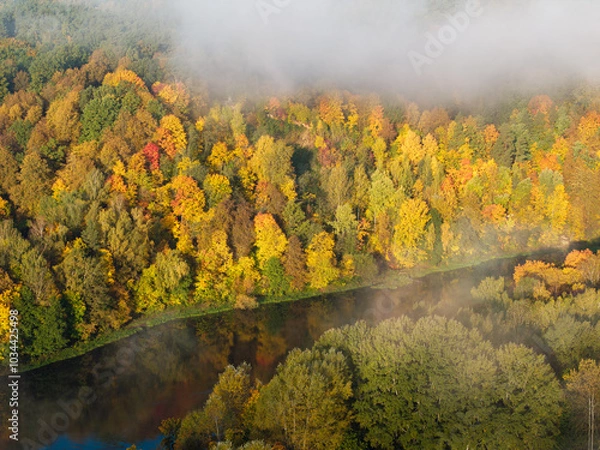 Fototapeta Autumn forest and river through the clouds