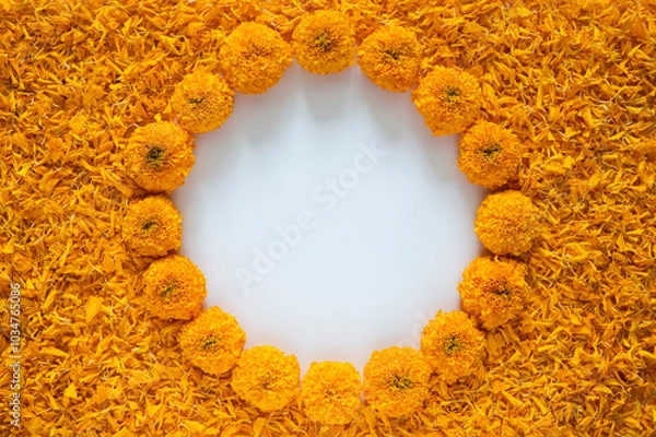 Fototapeta Decorative orange color marigold flowers and petals rangoli for Diwali festival with white space background.