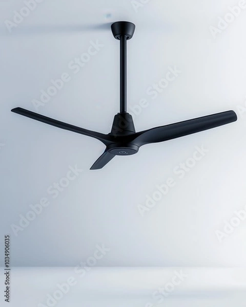 Fototapeta A sleek black ceiling fan with three blades, mounted on a simple rod from the ceiling, set against a minimalistic background.