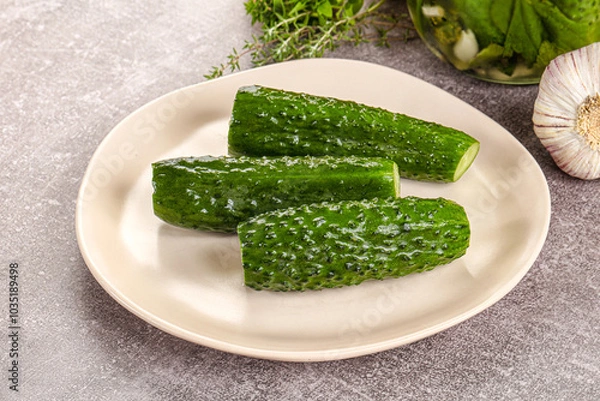 Fototapeta Homemade lighty salted cucumbers with herbs