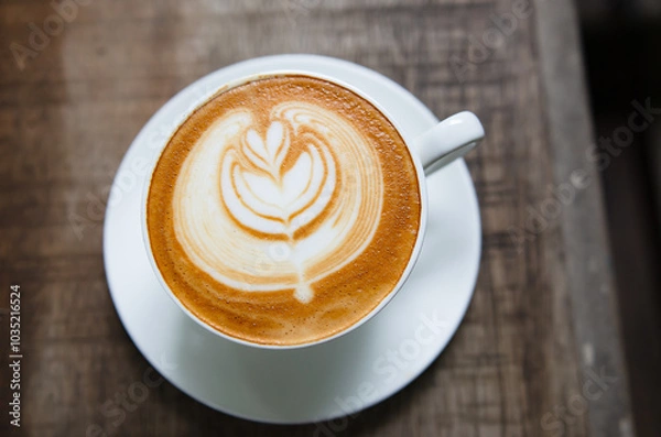 Fototapeta Latte Coffee on a Wooden Table A Warm Morning Moment