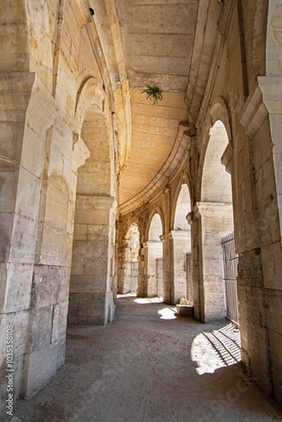 Fototapeta Wander through the ancient stone pathways of the Arles Roman Era Amphitheater, where cave-like passages and carved steps create a mystical journey. Each step echoes with history, inviting exploration
