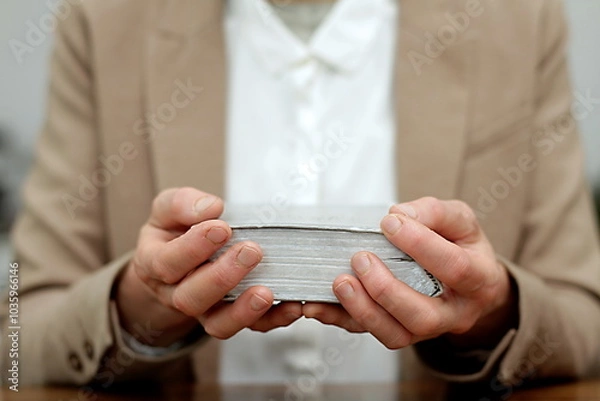 Fototapeta praying to god with hands together with crucifix cross on black background with people stock photo stock image	