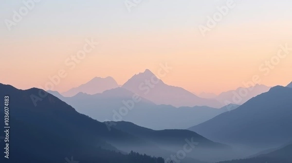 Obraz Sunrise over serene mountain ranges with misty valleys in the early morning light captured in a tranquil landscape