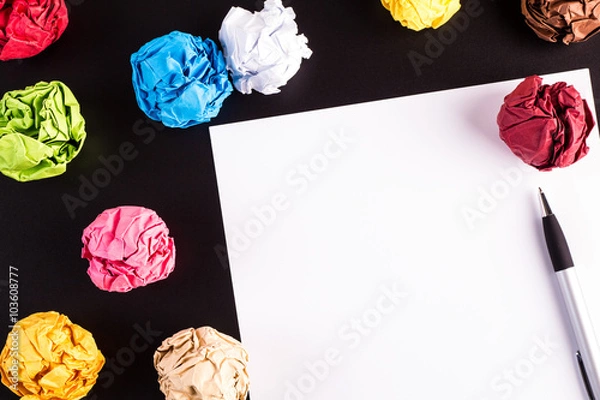 Obraz Creased color papers on black table