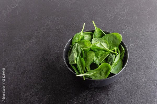 Obraz Fresh green spinach leaves in the bowl. Natural vegetarian food.
