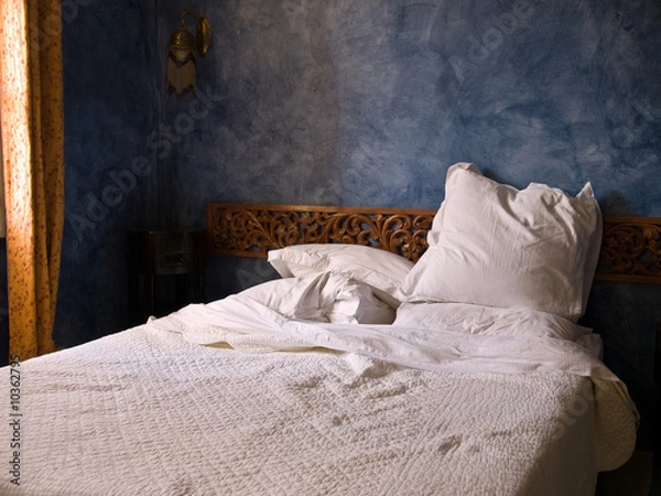 Obraz bedroom in the morning light with pillows threw askew.