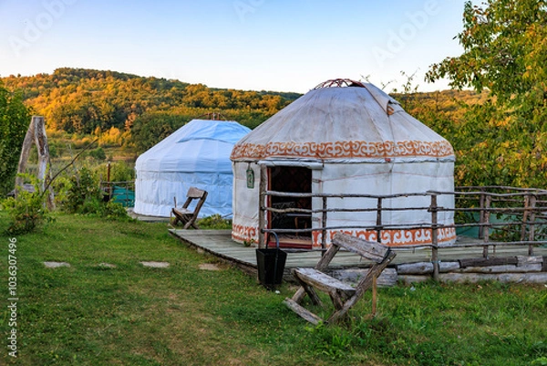Fototapeta Two tents are sitting in a grassy field, kyrgyz authentic nomadic yurt