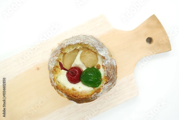 Fototapeta cream puff or choux pastry filled with cherries isolated on white background