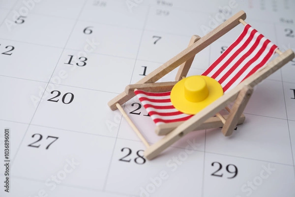 Fototapeta Red beach chair and hat on white blank calendar background copy space. Annual leave travel period for relaxation concept. Period of paid time off (PTO) granted to employees by their employer.