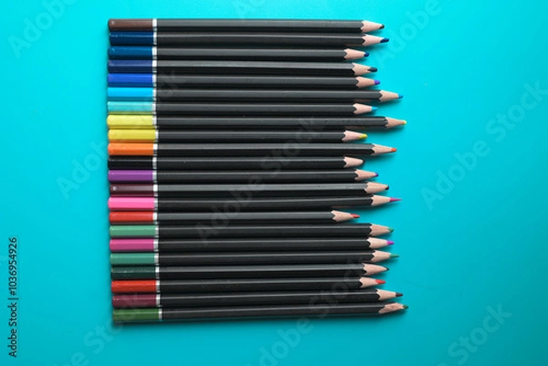 Obraz multi-colored pencils for drawing on a blue table