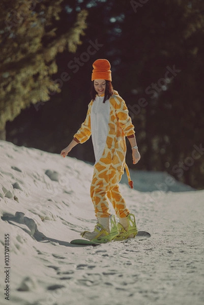 Obraz  A girl with a snowboard in her hands against the backdrop of snowy mountains
