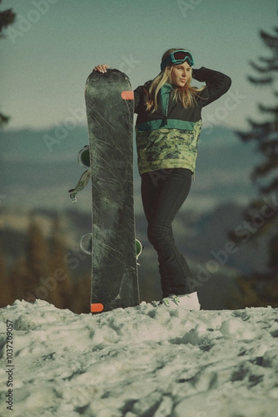 Obraz  A girl with a snowboard in her hands against the backdrop of snowy mountains