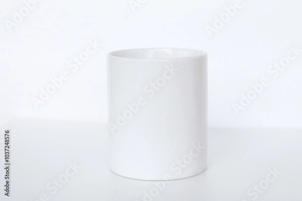 Fototapeta Elegant white ceramic mug isolated on a blank background, suitable for product marketing, mockups, and graphic design