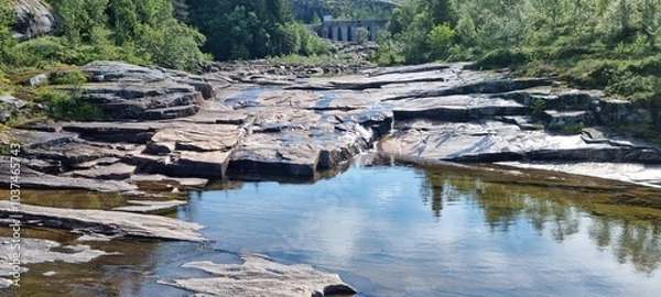 Fototapeta low water level in dammed river stream from mountain