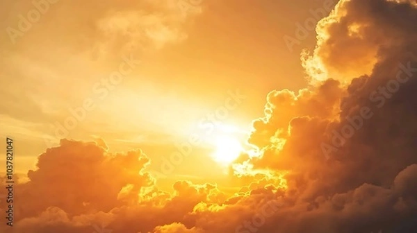 Fototapeta A golden hour sky just before sunset, with the sun casting a warm, soft glow over the clouds