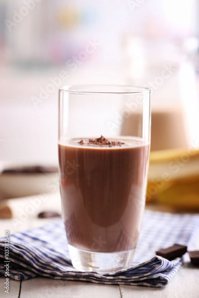 Fototapeta Glass of chocolate milk on table close-up