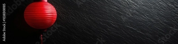 Fototapeta Red lantern on dark textured background with space for text