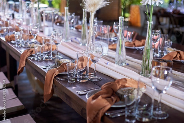 Fototapeta Wedding decoration. Floristics. Vessels with candles and bulk wax. Transparency and ease of design. Blue flowers and pampas.