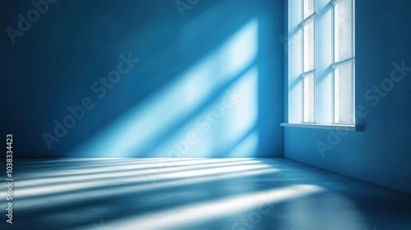 Fototapeta Soft beams of light illuminate a serene blue room with a smooth floor in gentle ambiance