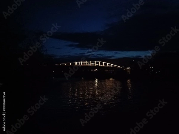 Obraz Pont sombre reflété dans le canal en soirée