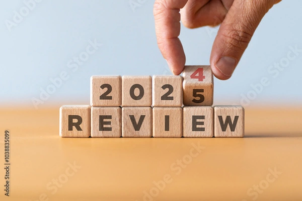Fototapeta Hand flipping of 2024 to 2025 on wooden blocks. 2024 business and customer review for business strategic planning in the next year 2025. End of the year business concept..