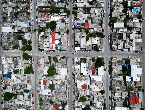 Obraz Aerial top-down view high altitude of slum a heavily populated urban informal settlement characterized by substandard housing and squalor poor living conditions streets and rusty metal home roof tops