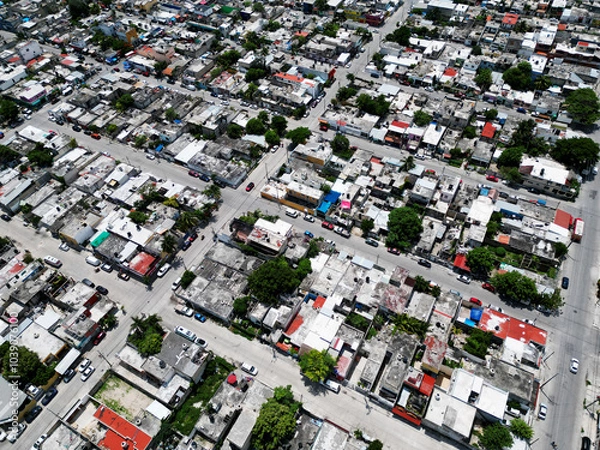 Obraz Aerial top-down view high altitude of slum a heavily populated urban informal settlement characterized by substandard housing and squalor poor living conditions streets and rusty metal home roof tops