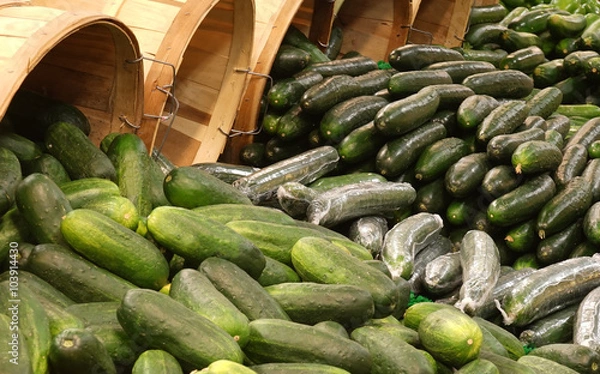 Fototapeta Cucumbers spilling from baskets
