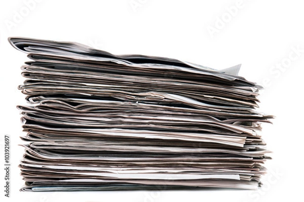 Fototapeta View of a pile of newspapers stacked isolated on a white background.