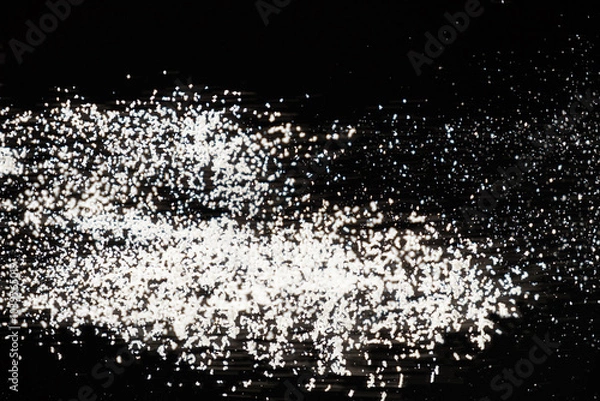 Fototapeta Abstract black and white background of pouring flour, space for text