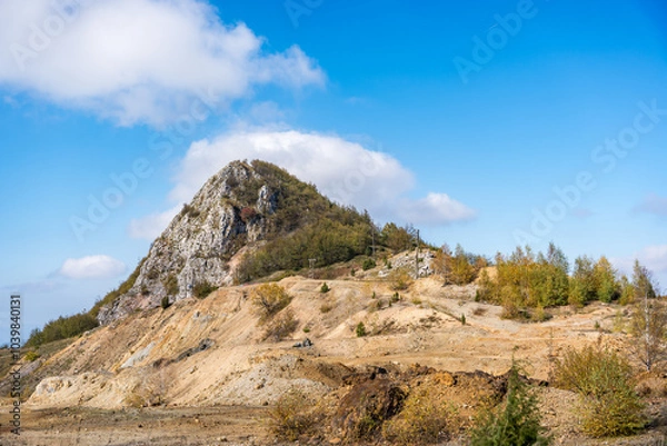 Obraz Abandoned and closed barite mine on Bobija mountain in Western Serbia, near the town of Valjevo. Remains of ruined nature with a tailings dump and a toxic lake with copper-colored water.