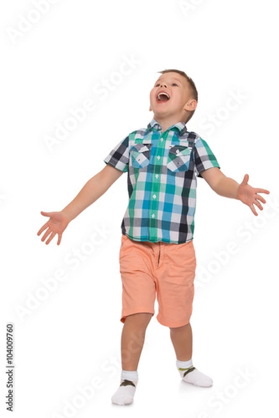 Fototapeta Little boy in pink shorts and a summer shirt with short sleeves, gestures with hands and shouting with its mouth wide open - Isolated on white background