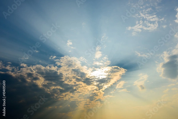 Obraz  sun rays are striking through the clouds