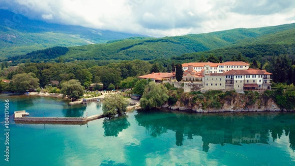 Fototapeta Sveti Naum Monastery by Lake Ohrid in Macedonia surrounded by lush greenery and serene waters on a clear day