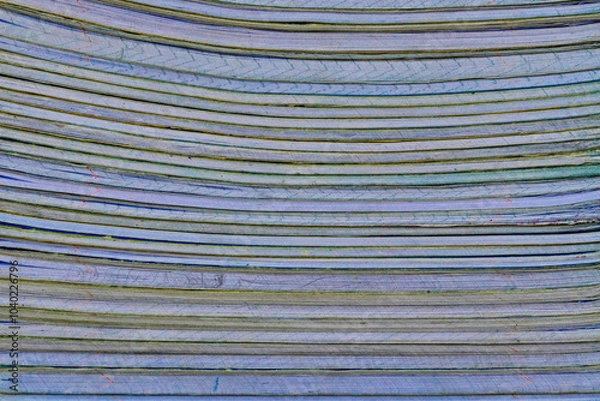 Fototapeta .Close-up of a large stack of books with horizontal lines running through them. The papers are stacked to create a repeating pattern.