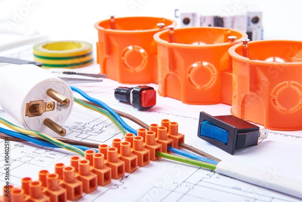 Fototapeta Components for use in electrical installations. Plug, connectors, junction box, switch, isolation tape and 

wires. Accessories for engineering work, energy concept.

