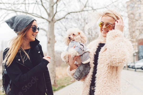 Obraz two young caucasian cute girls portrait with dog outdoor in park walking happy and smile all the way
