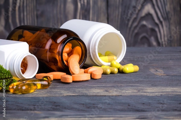 Obraz Various pills and containers with green leaves