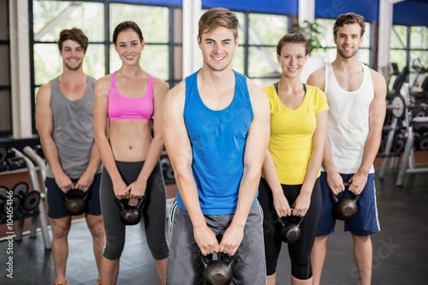 Fototapeta Fitness class lifting dumbbells