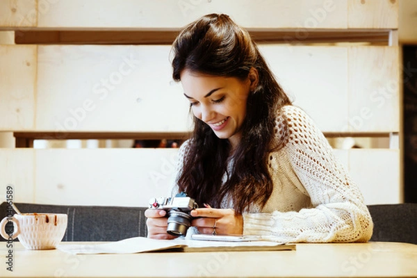 Obraz Charming woman sitting at the table with cup of coffee