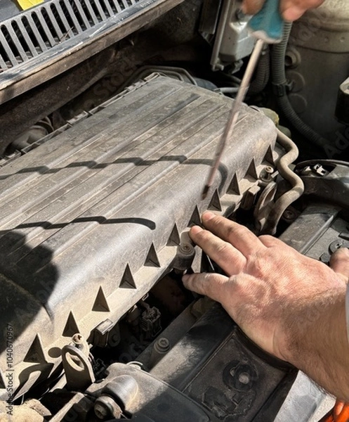 Obraz mechanic changing the engine
