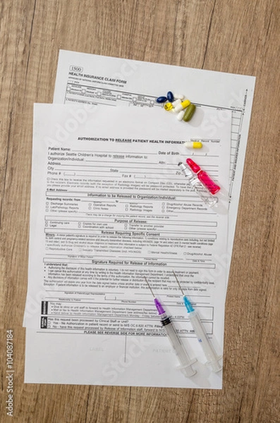 Obraz Medical patient form with pills and  syringes on  table