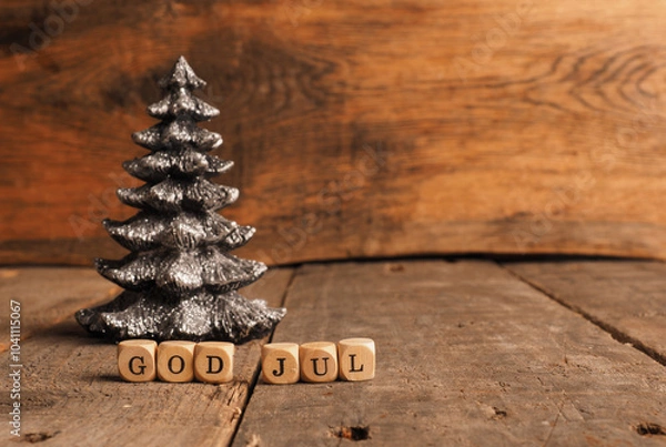 Fototapeta Wooden blocks with the words God Jul, Scandinavian Merry Christmas, Christmas tree shape on a wooden background with space for your text or product
